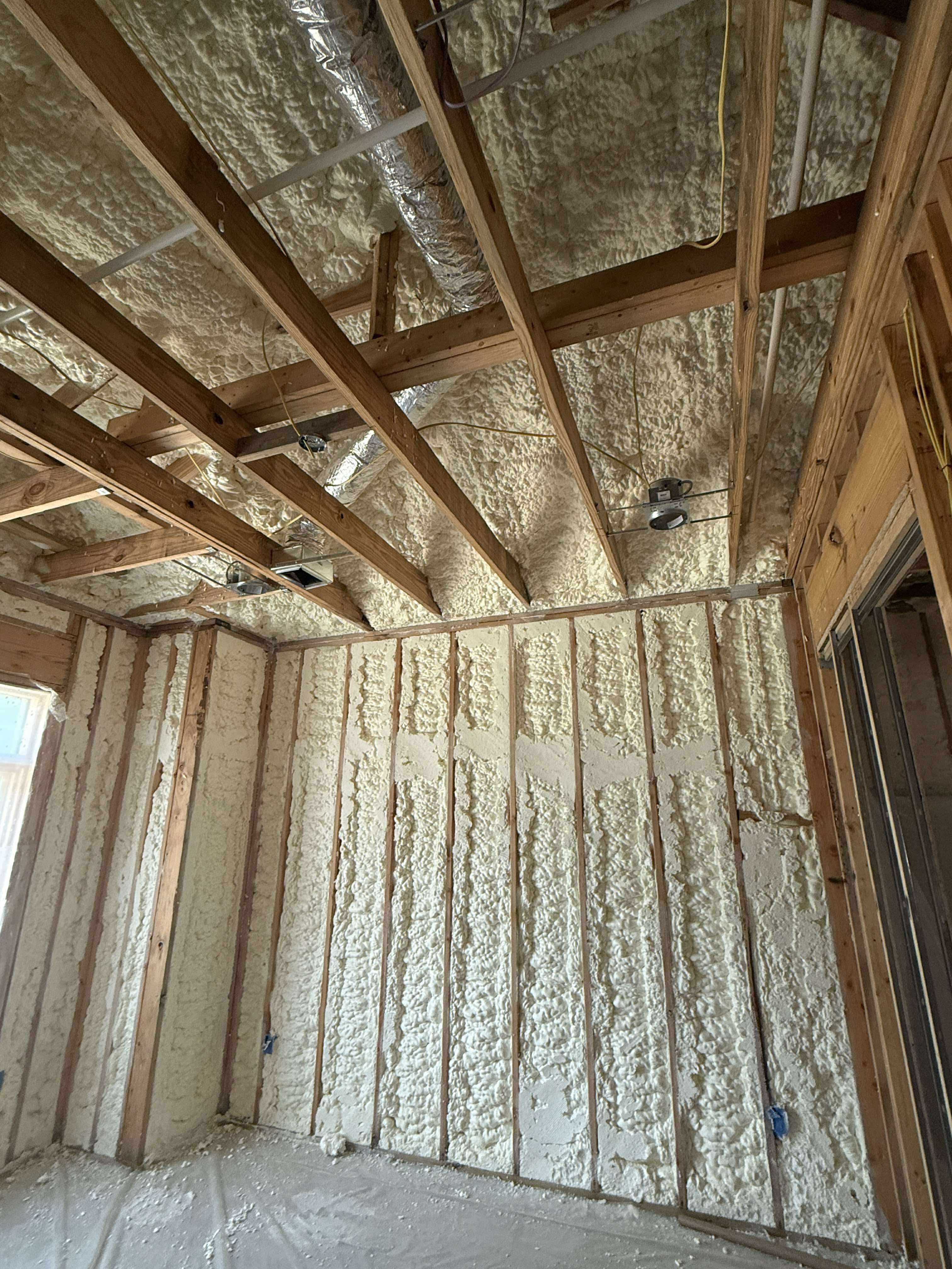 Spray foam insulating attic roof decking