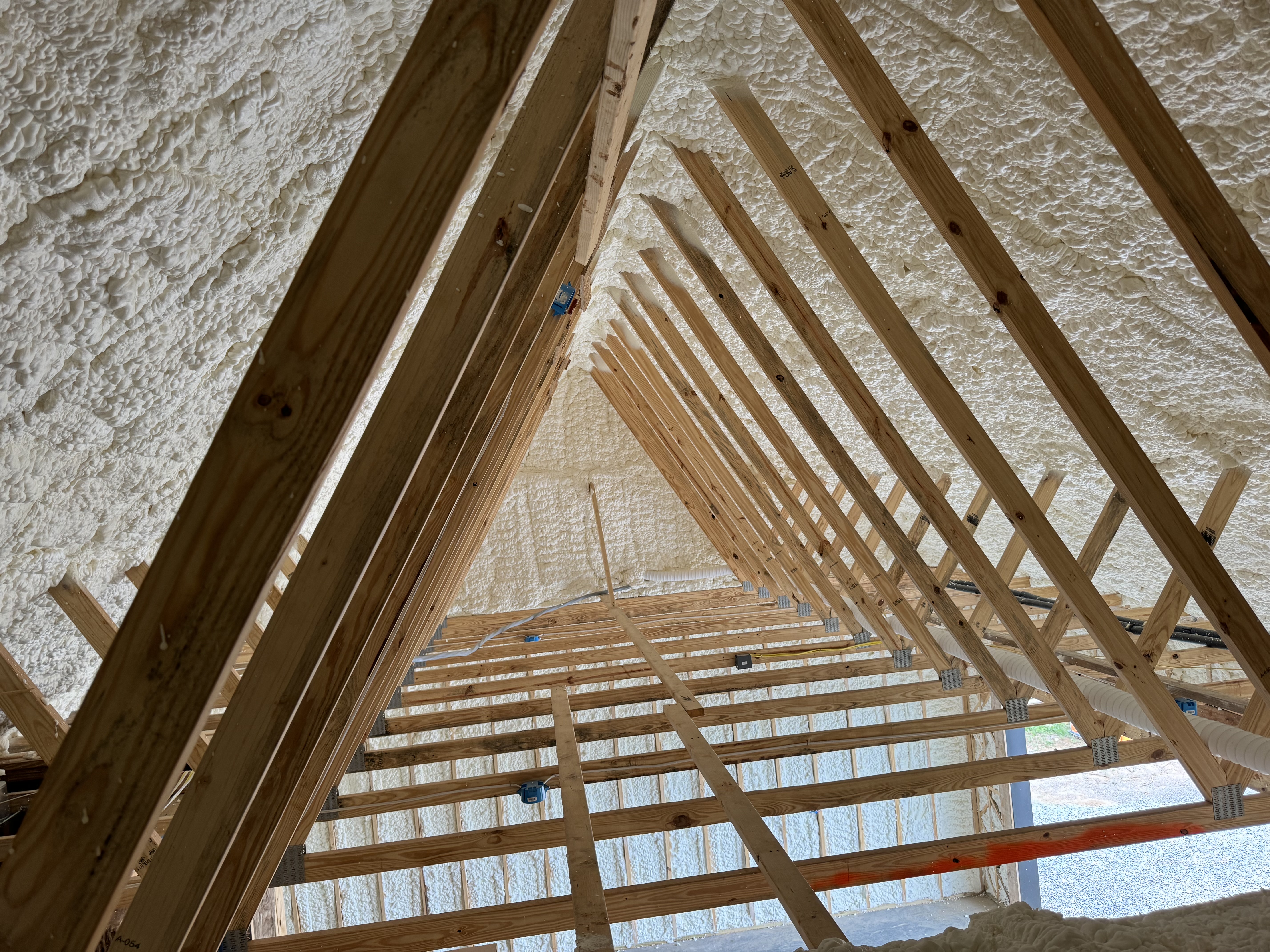 Spray foam crew insulating a garage ceiling